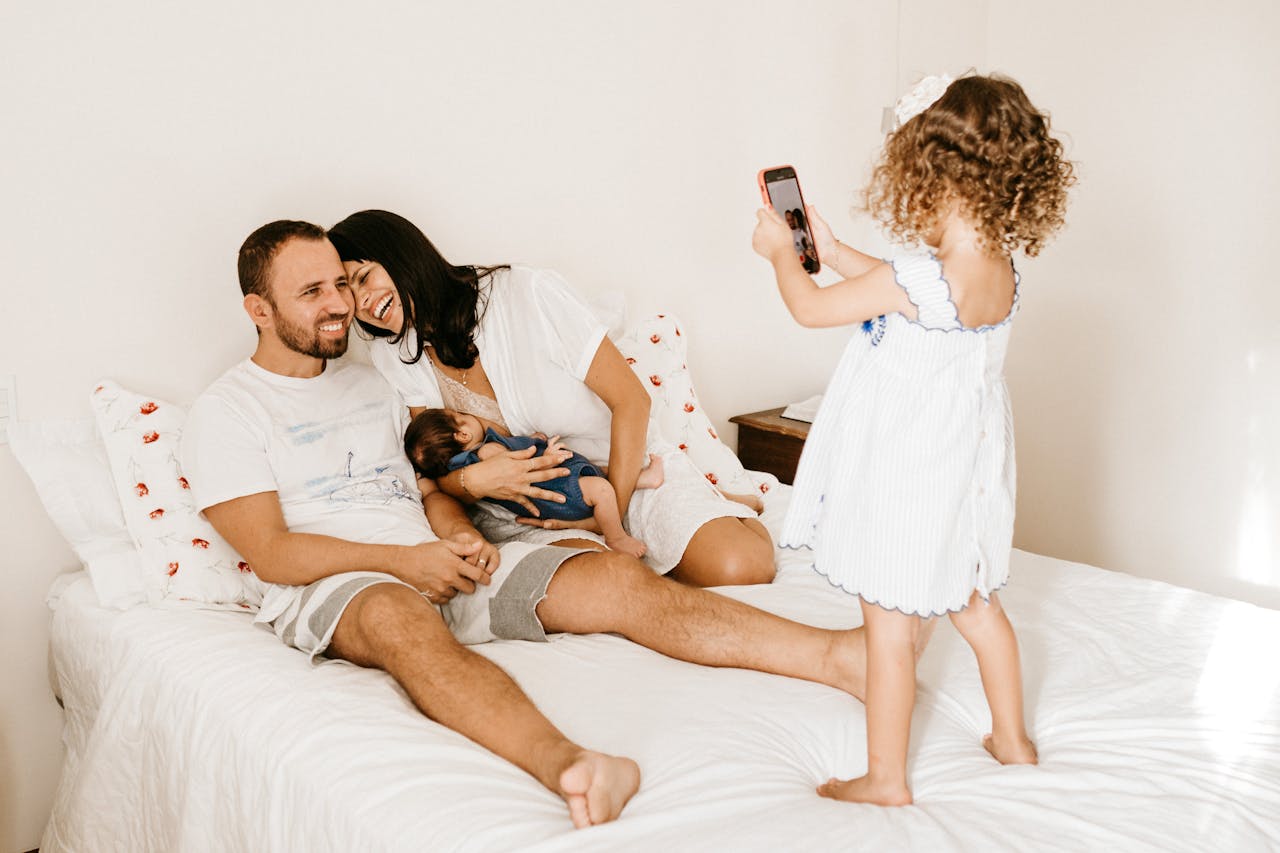 Toddler Taking a Photo of her Parents